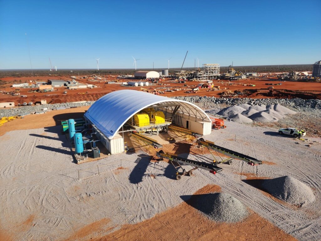 Large-scale dome shelter protecting equipment on red earth mining operation site